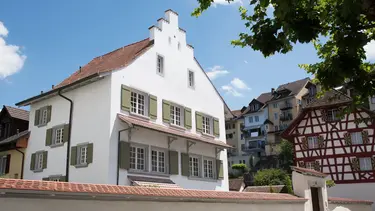 Produits de crépissage historiquement corrects et bâtiment historique avec façade crépie blanche en état restauré