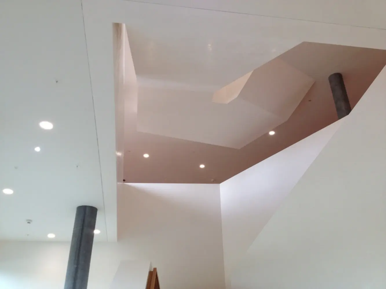 Blick zur Decke des Treppenaufangs, abstrakte, geometrische Formen mit weissen Spot-Leuchten