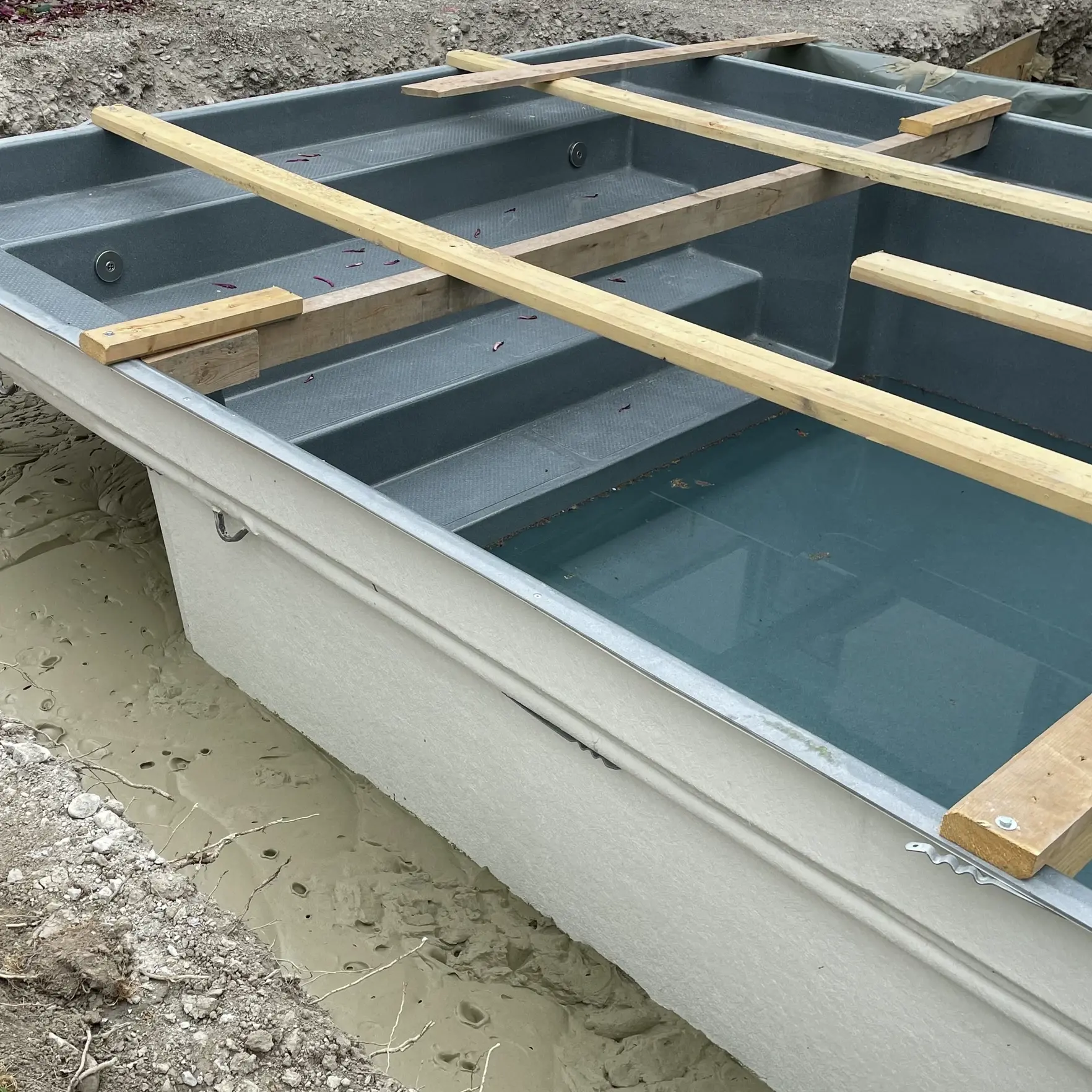 Coque en PRV à paroi épaisse, teintée en gris foncé à l'intérieur et en blanc à l'extérieur, avec une ossature en bois et du béton cellulaire Fixit POR dans la première couche