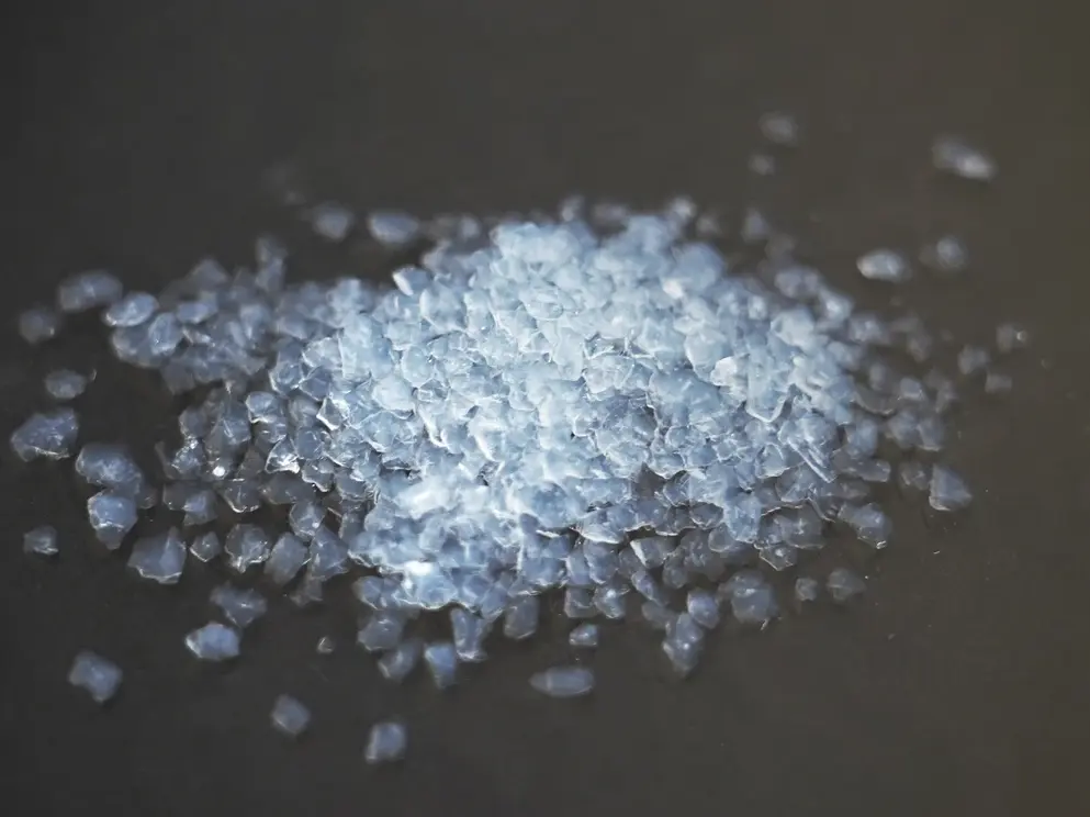 Slightly transparent aerogel insulation beads on a black surface