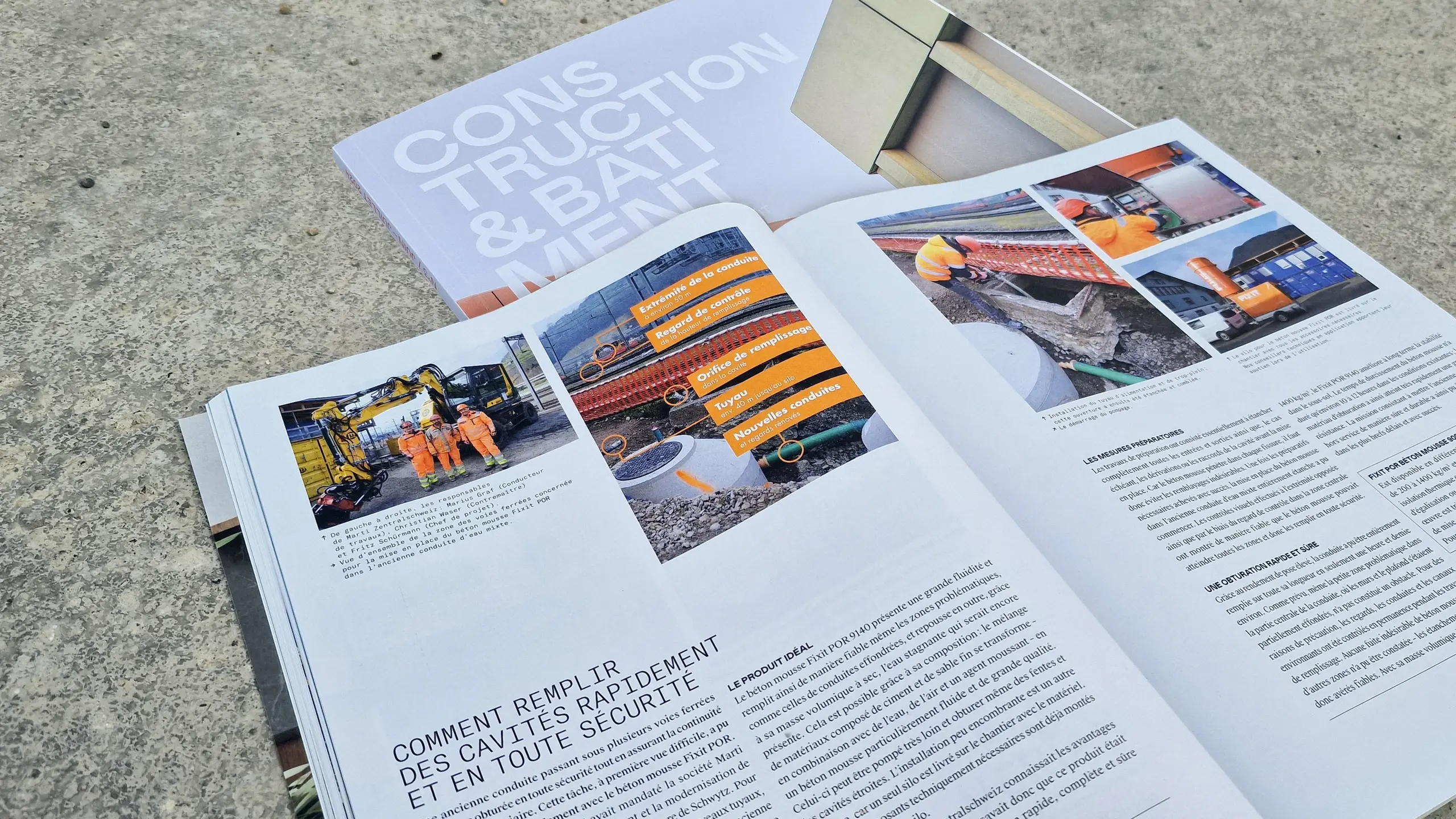 Couverture du magazine « Construction Bâtiment » avec l'article ouvert sur le remplissage de conduites avec Fixit POR à la gare de Schwyz