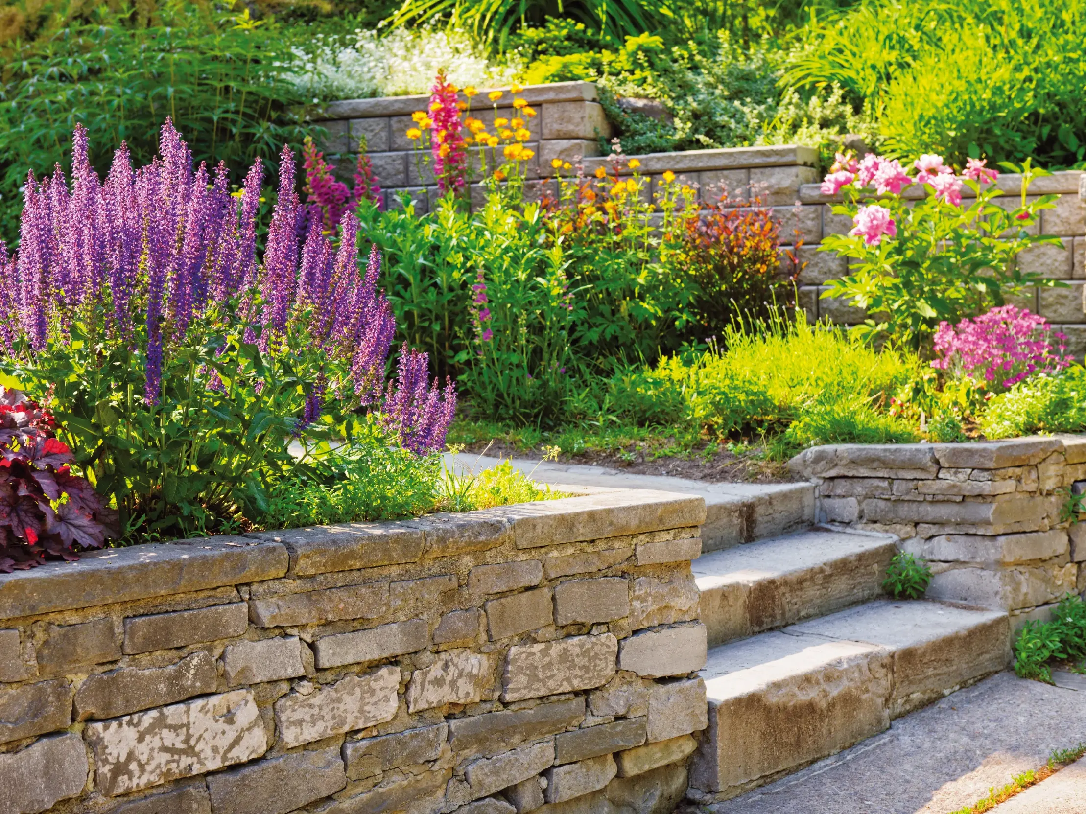 Eine Gartenlandschaft mit sauber verarbeiteten Natursteinmauern