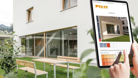 Fixit Fassadenkonfigurator auf einem Tablet mit einem Neubau und der Aussenfassade im Hintergrund