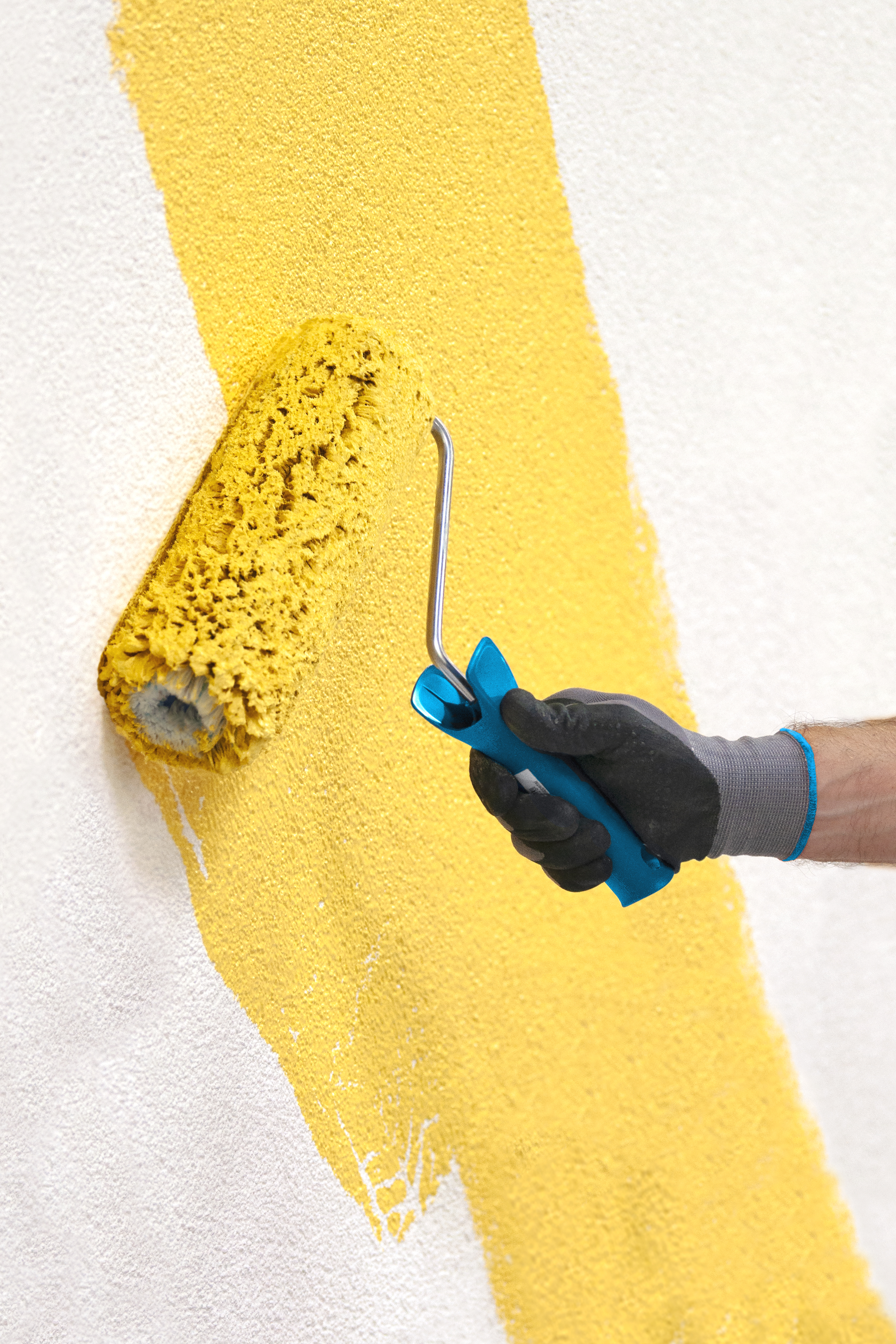Worker applies a coat of paint