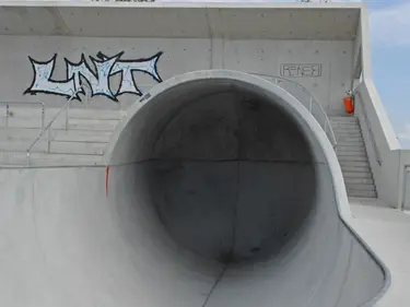 Ein betonierter Skatepark mit glatten, geschwungenen Rampen