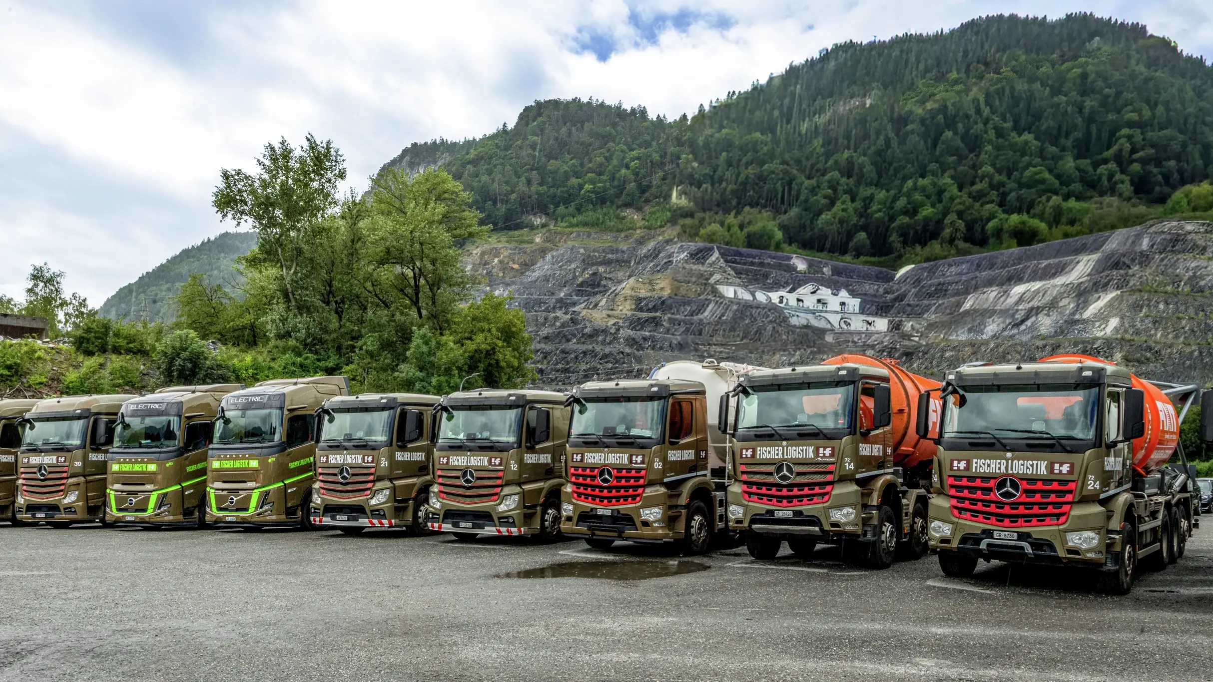 Mehr als acht LKW sind nebeneinander aufgereiht, die Ansicht ist Frontal